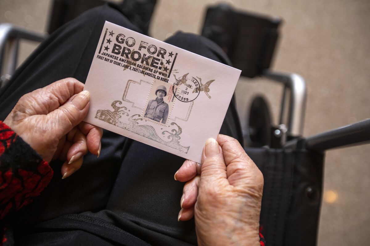 Closeup of a card being held by a person in a wheelchair.