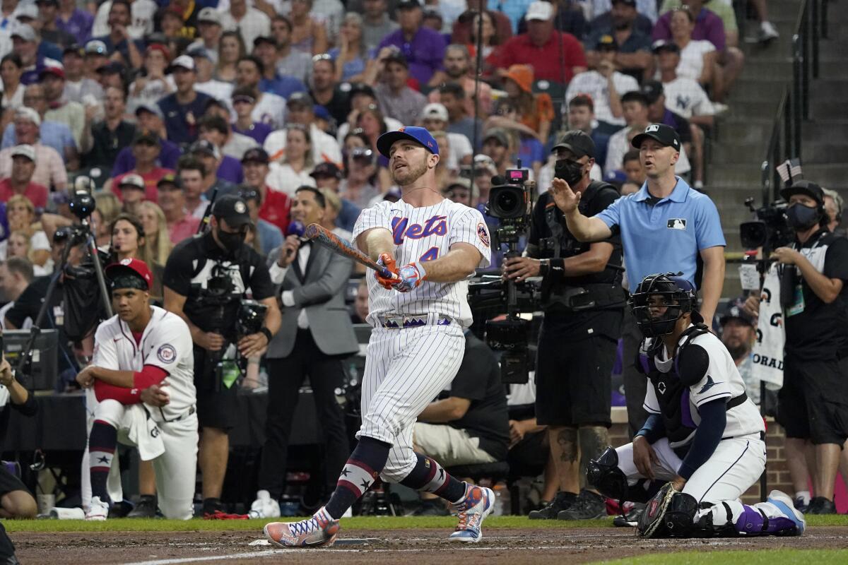 FILE - National League's Pete Alonso, center, of the New York Mets, hits during the second round of the MLB All Star baseball Home Run Derby, July 12, 2021, in Denver. A new baseball rule says that if the All-Star Game is tied after nine innings, a Home Run Derby will decide the winner. (AP Photo/Gabriel Christus, File)