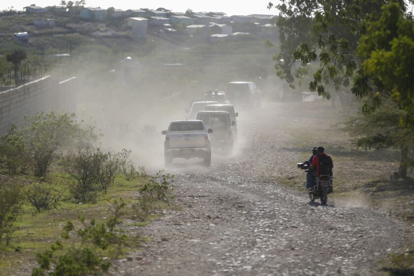 A caravan drives to the airport after departing from the Christian Aid Ministries headquarters at Titanyen, north of Port-au-Prince, Haiti, Dec. 16, 2021. Twelve remaining members of a U.S.-based missionary group who were kidnapped two months ago have been freed, according to the group and to Haitian police. (AP Photo/Odelyn Joseph)