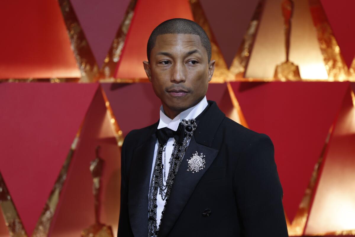 A man in a tuxedo on the Oscars red carpet.