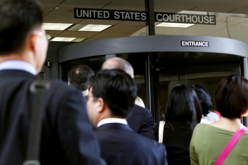 Individuals line up to enter the Robert F. Peckham United States Courthouse Building to watch Apple and Samsung face each other in federal district court for a patent infringement case on July 30, 2012 in San Jose, California. Jury selection was set to open Monday in a US federal court in the blockbuster patent case pitting Apple against Samsung, which accuse each other of copying patents for smartphones and tablets. Apple is seeking more than $2.5 billion in a case accusing the South Korean firm of infringing on designs and other patents from the iPhone and iPad maker in the trial in San Jose, California, federal court. Samsung counters that Apple infringed on its patents for wireless communication, so the jury will sort out the competing claims. AFP PHOTO/ Beck Diefenbach (Photo credit should read Beck Diefenbach/AFP/GettyImages)