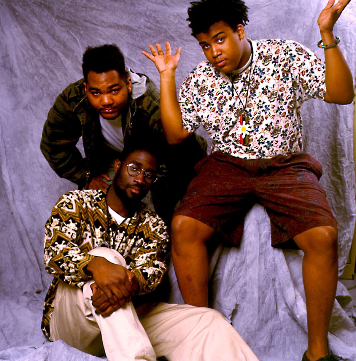 Three guys in a hip-hop group pose for a portrait in the late 1980s
