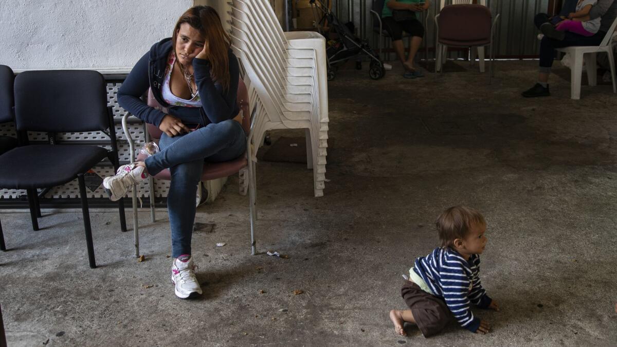 Synthia Savllon, 19, of Honduras spends long hours in a Tijuana shelter with her 1-year-old son, Jonathan. She is fleeing an abusive boyfriend, who is a gang member.