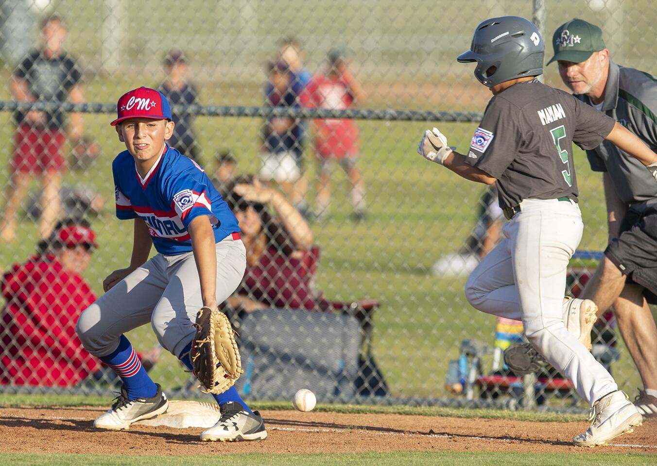 Costa Mesa National Little League's Nico Viramontes picks a ball clean for an out at first against Costa Mesa American Little League's Isaiah Mamian in the fifth inning during the Mayor's Cup Tuesday, July 9.