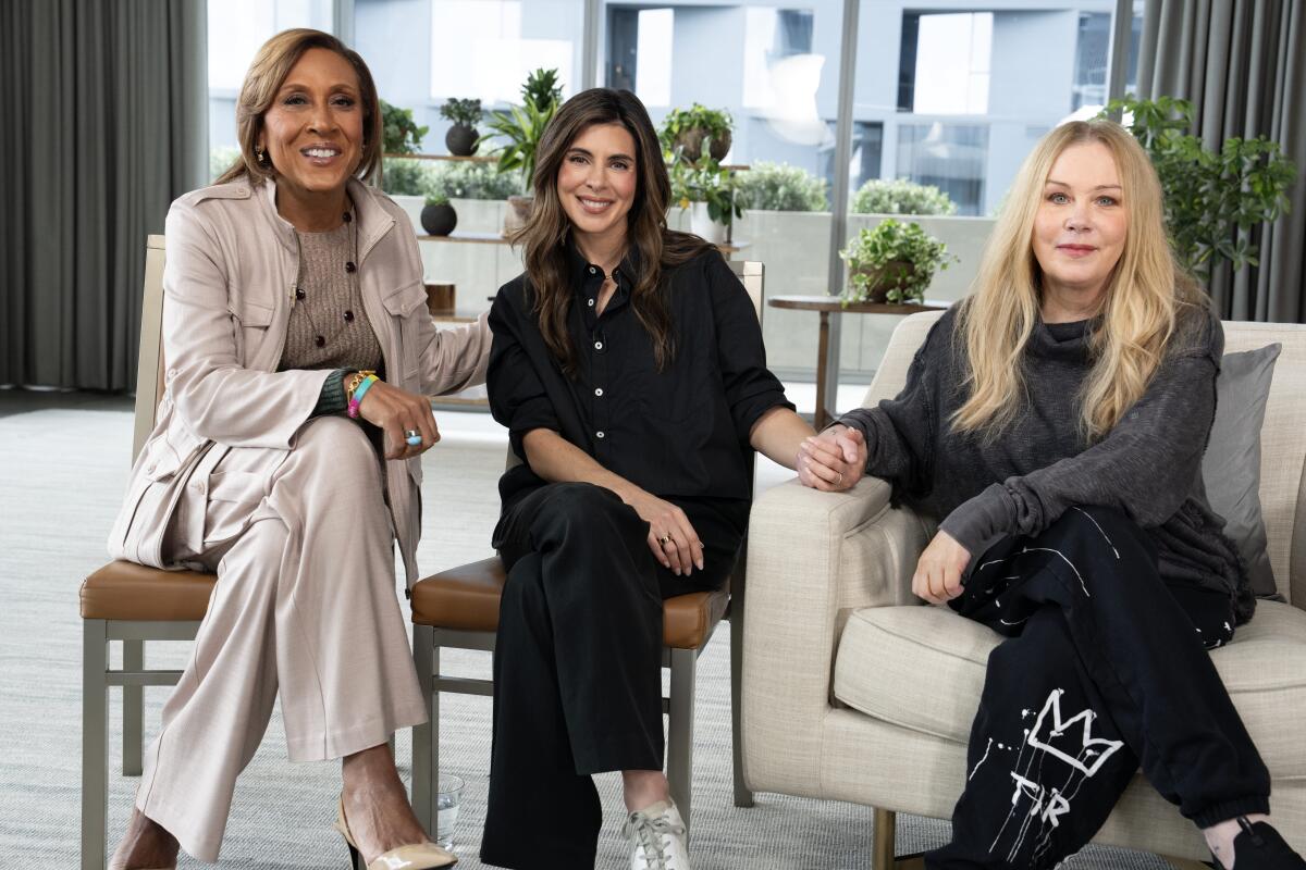 Robin Roberts, Jamie Lynn Sigler and Christina Applegate are seated and smile during an interview