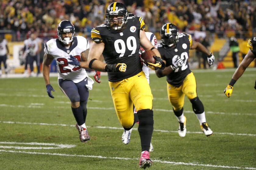 Pittsburgh Steelers defensive end Brett Keisel runs past Houston Texans running back Arian Foster after intercepting a pass during a game on Oct. 20.