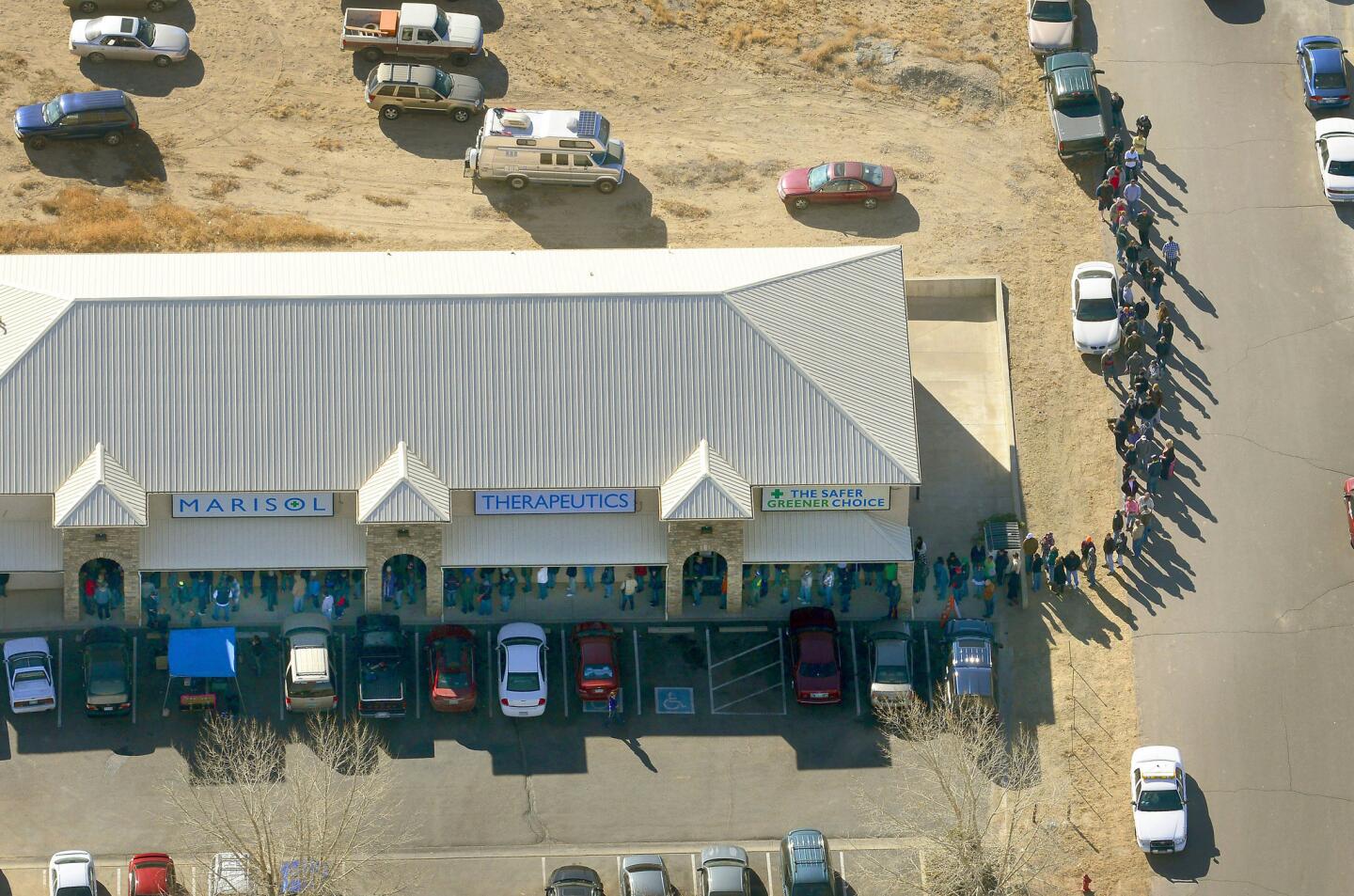 A long line of buyers trails from a store selling marijuana in Pueblo West, Colo., on Jan. 1 as the nation's first recreational pot industry opened its doors.