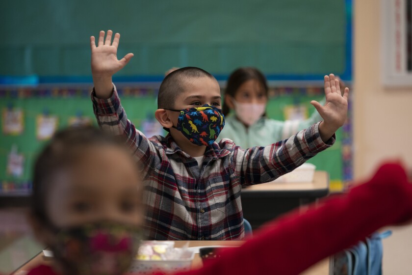 Kindergarten students participate in a classroom activity on the first day of in-person learning at Maurice Sendak Elementary School in Los Angeles, Tuesday, April 13, 2021. More than a year after the pandemic forced all of California's schools to close classroom doors, some of the state's largest school districts are slowly beginning to reopen this week for in-person instruction. (AP Photo/Jae C. Hong)