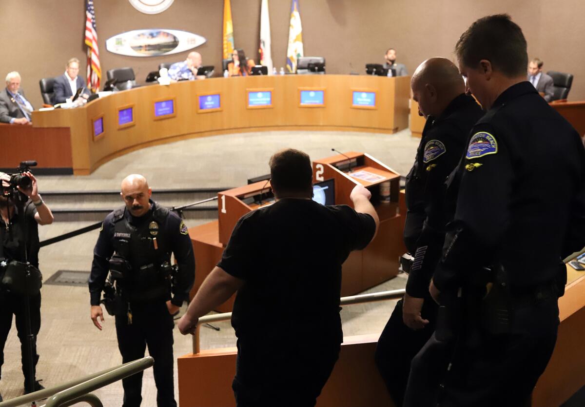 An unruly person was asked to leave the Huntington Beach City Council Chambers and escorted by the Huntington Beach police.