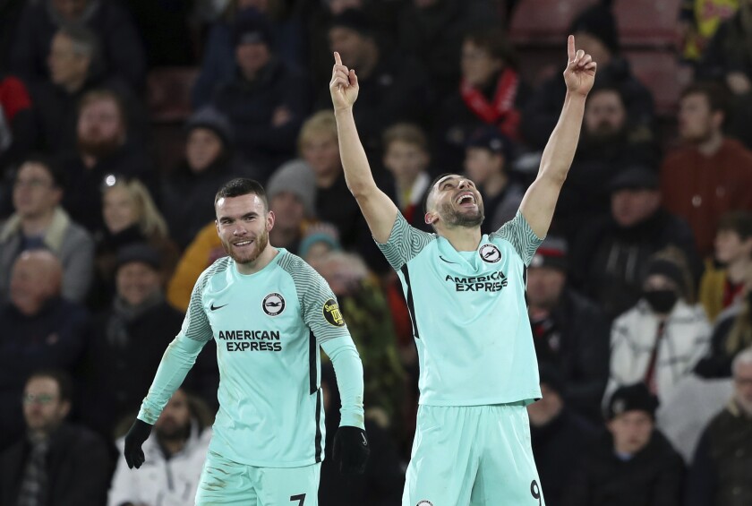 Brighton and Hove Albion's Neal Maupay celebrates scoring their side's first goal of the game battle for the ball during the English Premier League soccer match against Southampton at St. Mary's Stadium, Southampton, England, Saturday, Dec. 4, 2021. (Kieran Cleeves/PA via AP)