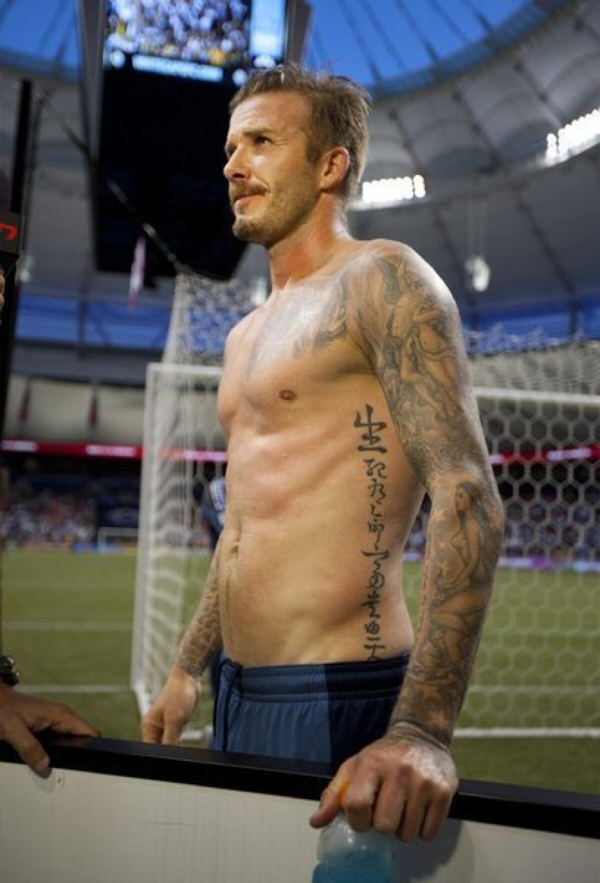 David Beckham, on the sidelines in this file photo, shows the abssets, er, assets, that made him a natural as an underwear designer and model.