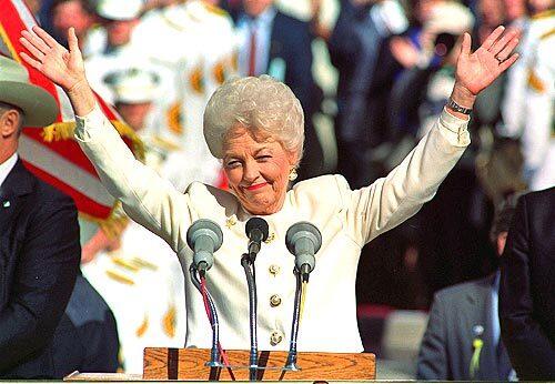 Ann Richards raises both arms in celebration after being sworn in as governor of Texas in Austin, Texas, in 1991.