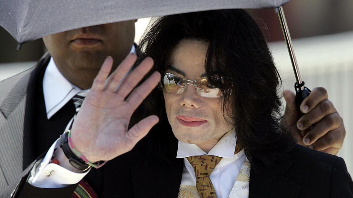 Jackson waves as he leaves the Santa Barbara courthouse in June 2005.