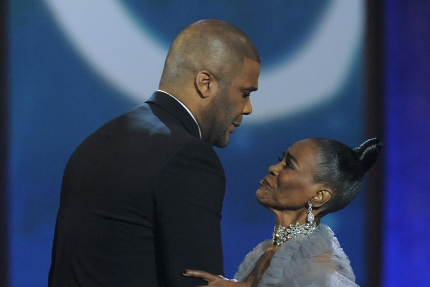 Tyler Perry hugging Cicely Tyson on stage