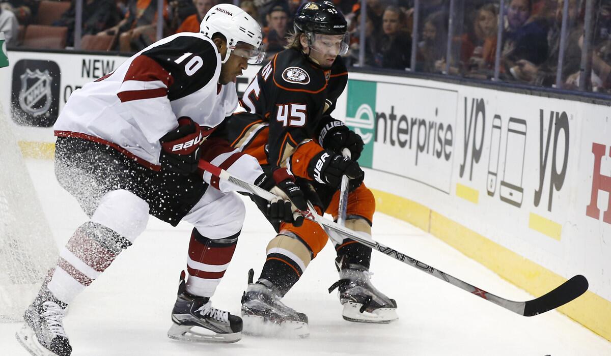 Arizona Coyotes' Anthony Duclair, left, battles Anaheim Ducks defenseman Sami Vatanen in the first period on Friday.