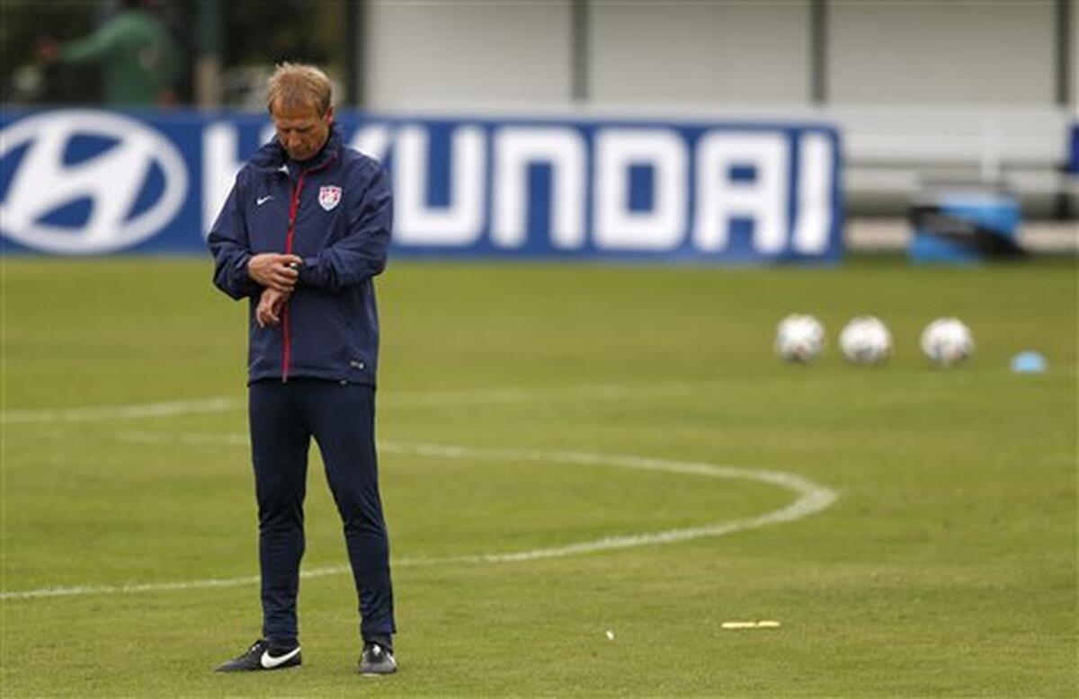 U.S. Coach Juergen Klinsmann checks his watch before the start of a training session in Sao Paulo, Brazil on June 11, 2014.