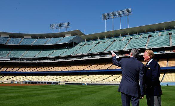 Los Angeles Dodgers announcer Vin Scully, right, talks with team owner Frank McCourt before McCourt unveiled a multifaceted stadium improvement plan at a press conference Thursday.