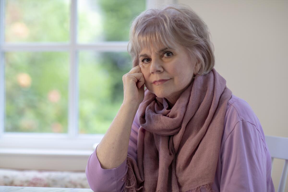 A woman seated near a window