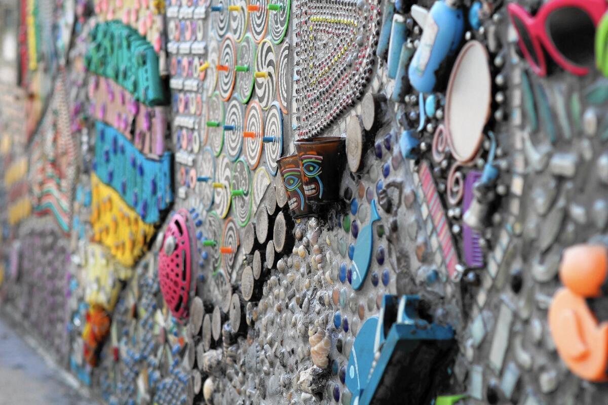 A detail shot of a mosaic Renee Howard has created at Color Lounge, a Burbank hair salon, using everyday items, including press-on fingernails, hair-trimmer guides and old computer components.