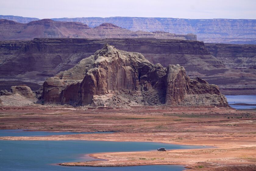 FILE - Low water levels at Wahweap Bay at Lake Powell along the Upper Colorado River Basin are shown, June 9, 2021, at the Utah and Arizona border at Wahweap, Ariz. The Biden administration announced Thursday, Feb. 2, 2023, that 15 Native American tribes will get a total of $580 million in federal money this year for water rights settlements. (AP Photo/Ross D. Franklin, File)