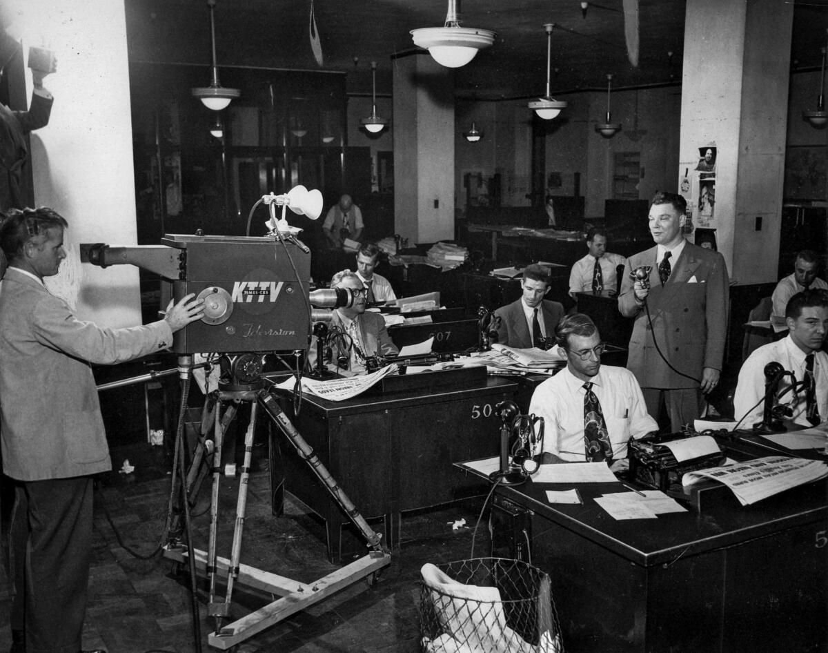 Nov. 7, 1950: In the Los Angeles Times City Room, reporter Bob Hartmann comments on the election results to KTTV. The Times owned KTTV from 1949 until 1963. The last three call letters stood for "Times TV."