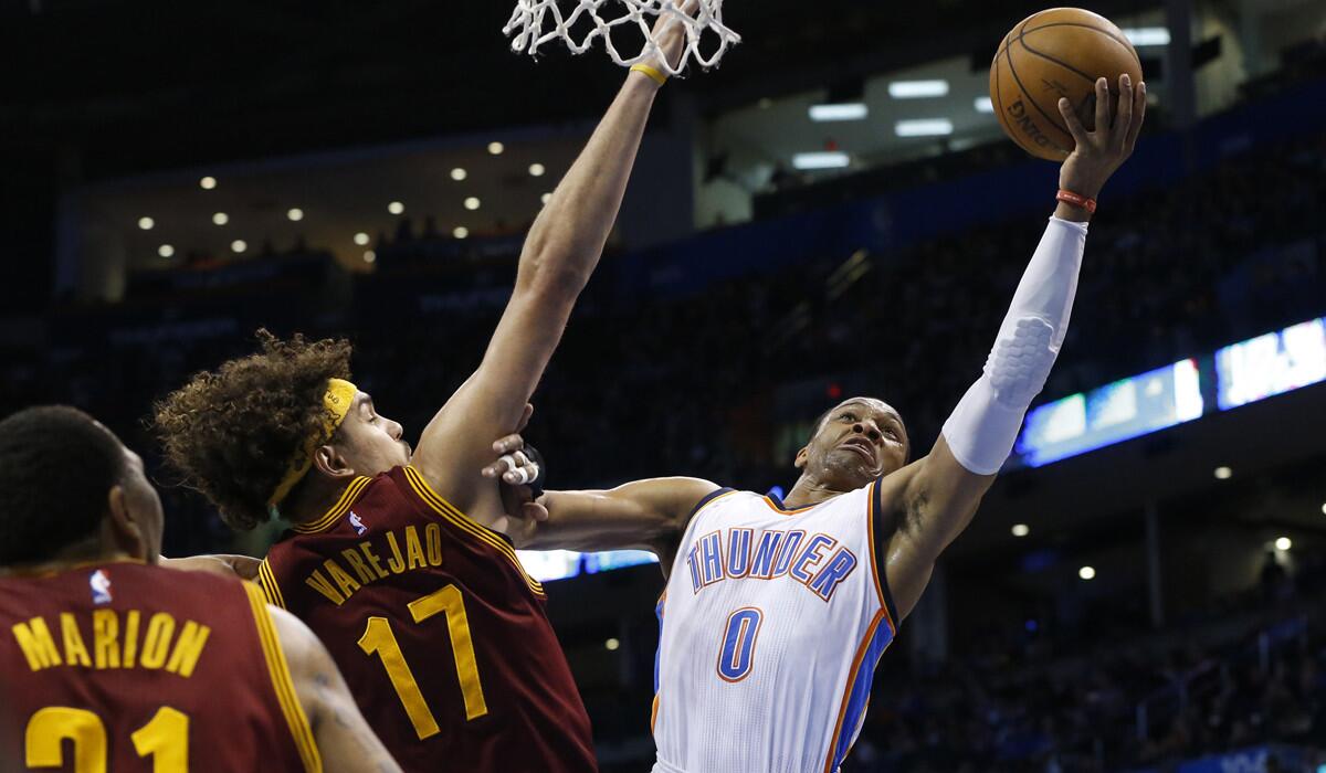 Thunder guard Russell Westbrook has his layup challenged by Cavaliers center Anderson Varejao during their game Thursday night in Oklahoma City.