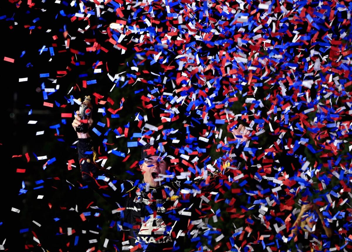 Jeff Gordon celebrates in victory lane after winning the NASCAR Sprint Cup at Kansas Speedway on Saturday.