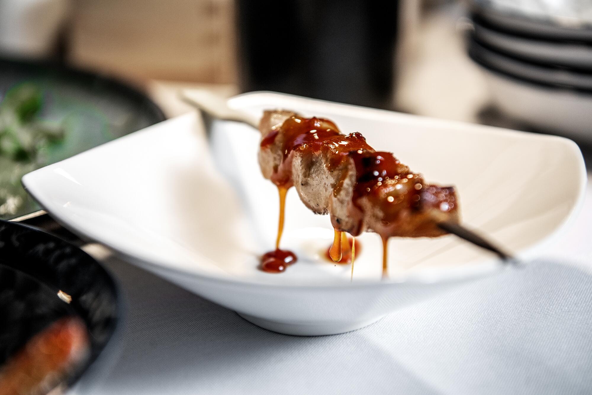 Pork jowl toro skewer with fish sauce caramel