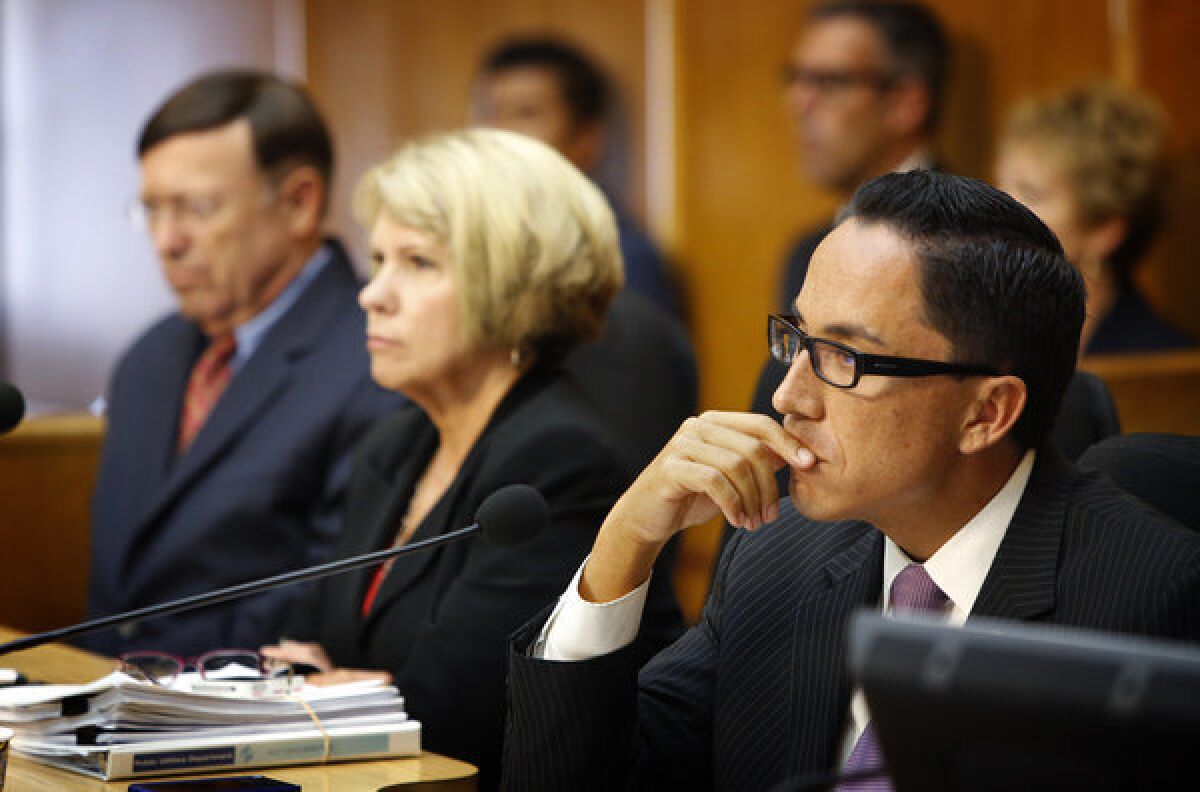 City Council President Todd Gloria, right, listens to public comment Friday before the council voted to accept a deal that includes Mayor Bob Filner's resignation. Gloria will serve as interim mayor until a replacement is elected.