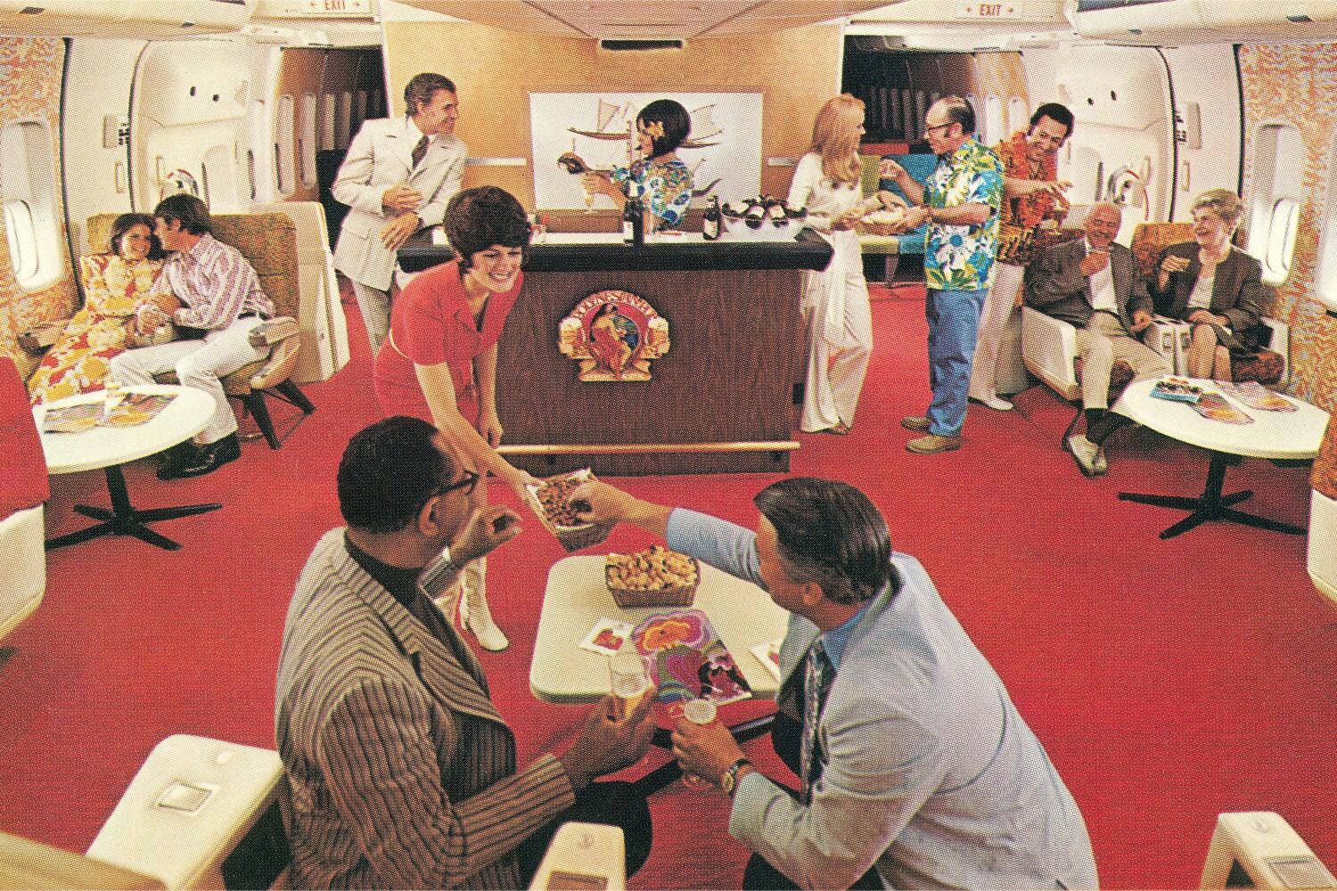 A waitress serving snacks in an airplane Party Lounge. (Photo by Found Image Holdings/Getty Images)