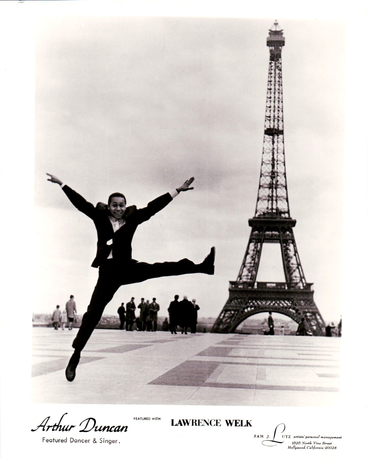 In a vintage publicity still, tap dancer Arthur Duncan is seen dancing ebulliently in front of the Eiffel Tower