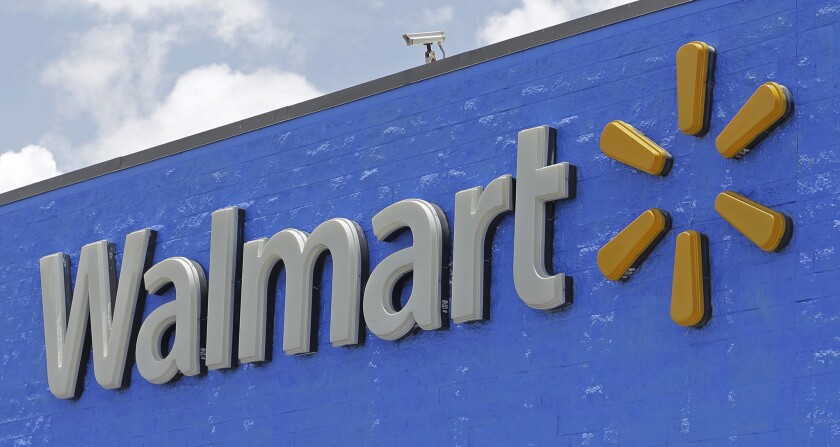 A Walmart sign. Walmart is the latest retailer to require masks at all its stores.