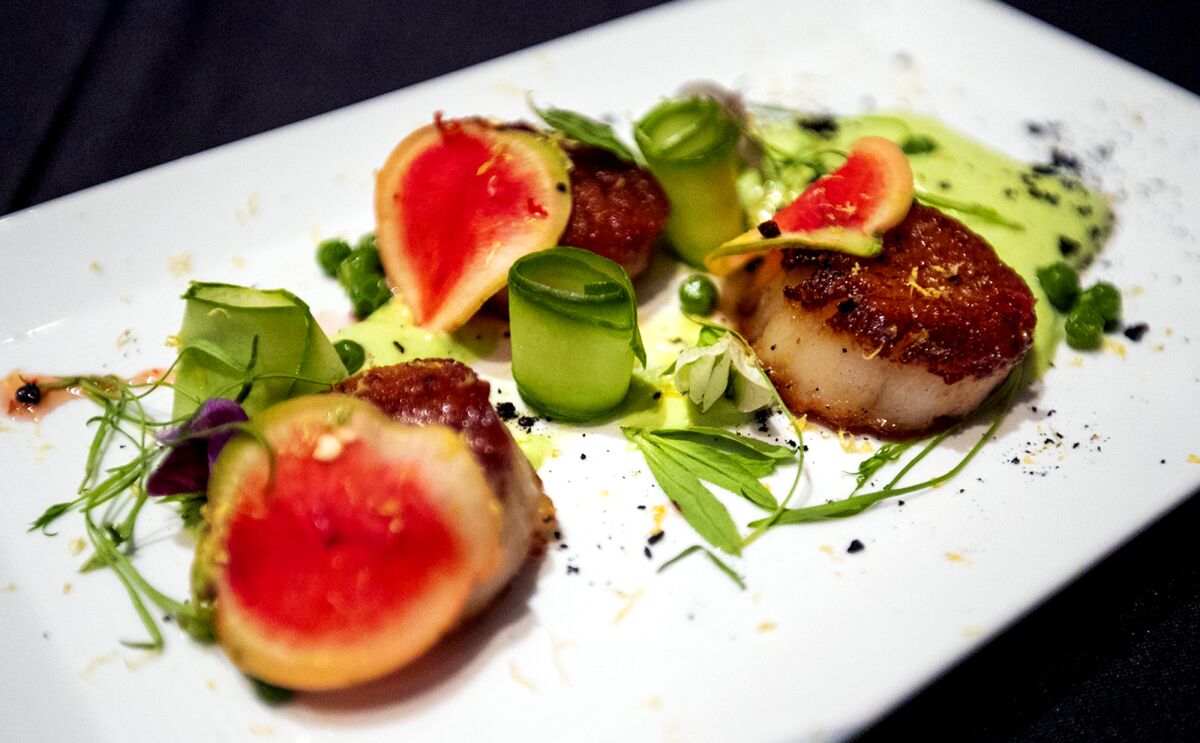 Students from OCSA present seared scallops with pea foam.