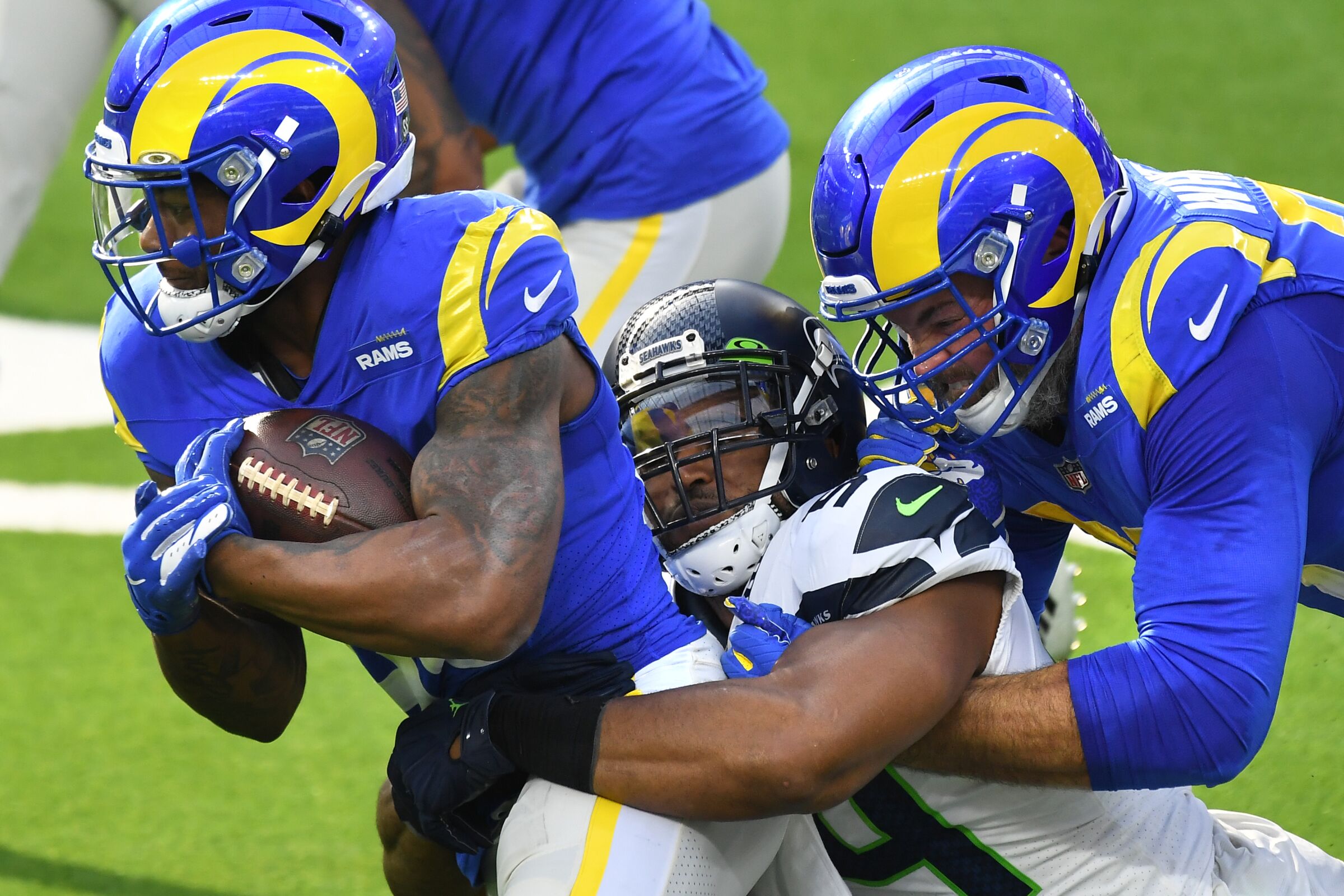 Rams running back Cam Akers gets a little help from offensive lineman Andrew Whitworth to pick up yards.