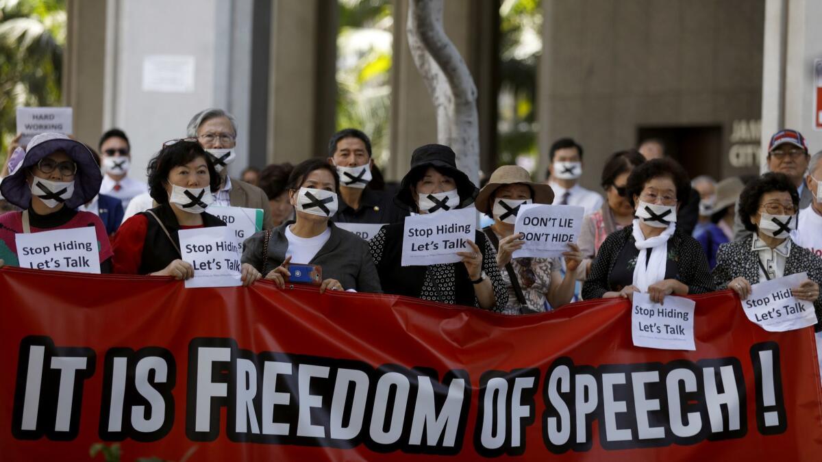 People take part in a rally in front of Los Angeles City Hall. Protesters have complained that Council President Herb Wesson ignored their concerns about temporarily housing.