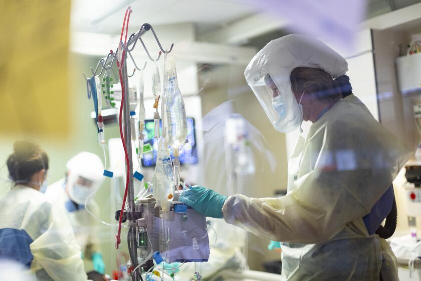 FILE - In this Aug. 31, 2021, file photo, Jack Kingsley R.N. attends to a COVID-19 patient in the Medical Intensive care unit (MICU) at St. Luke's Boise Medical Center in Boise, Idaho. Idaho public health leaders have activated "crisis standards of care" for the state's northern hospitals because there are more coronavirus patients than the institutions can handle. The Idaho Department of Health and Welfare made the announcement Tuesday, Sept. 7. (AP Photo/Kyle Green, File)