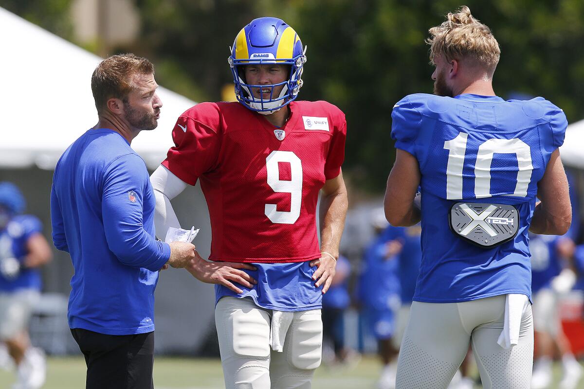 Coach Sean McVay, left, talks to quarterback Matthew Stafford (9) and wide receiver Cooper Kupp (10) at first open practice.