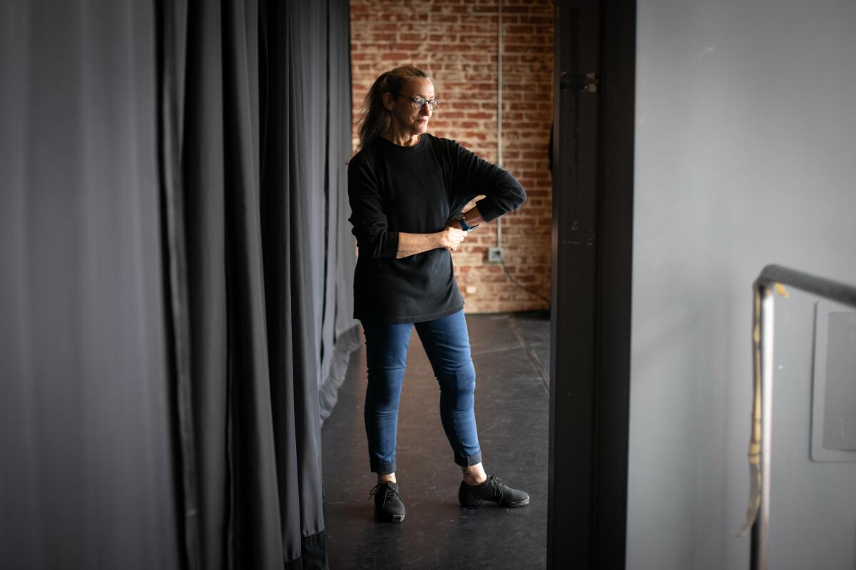 A woman standing in a dance studio.