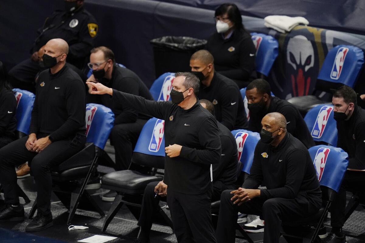 Lakers head coach Frank Vogel walks in front of the bench during a game against the New Orleans Pelicans on March 23.