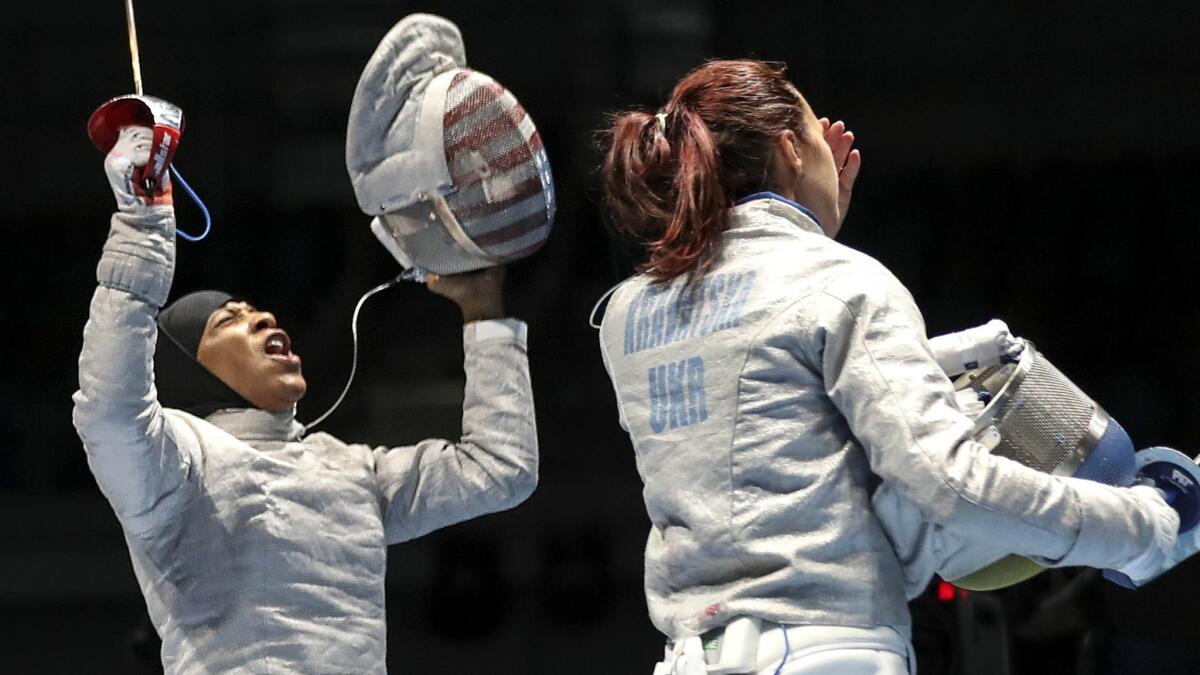 American fencer Ibtihaj Muhammad reacts after defeating Olena Kravatska of the Ukraine during a first-round match in the women's individual sabre competition on Monday.