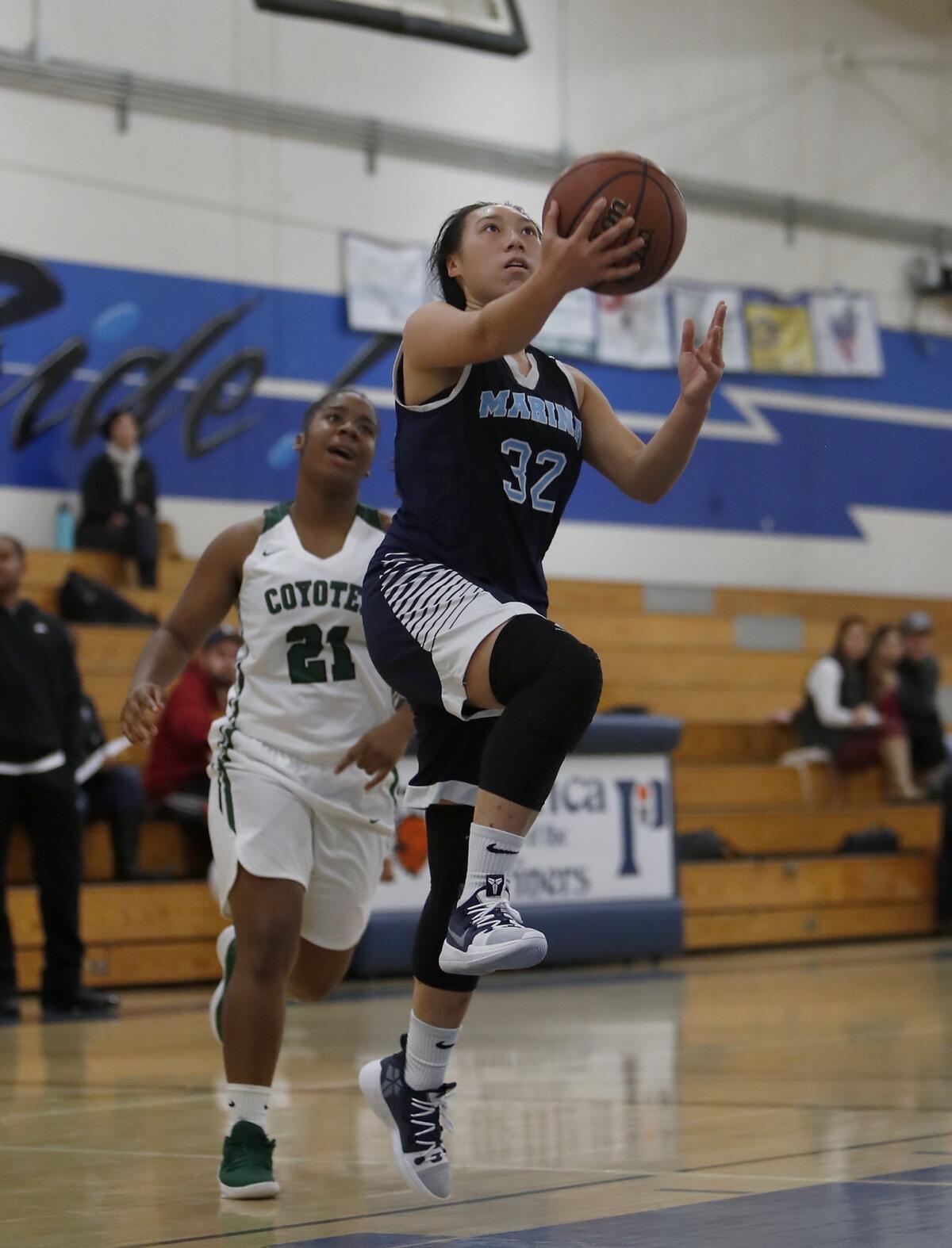 Marina's Katie Nguyen drives in for a layup against Buena Park in the first half of the Hawk Holiday Classic Soaring Flight game at Pacifica High on Dec. 6, 2018.
