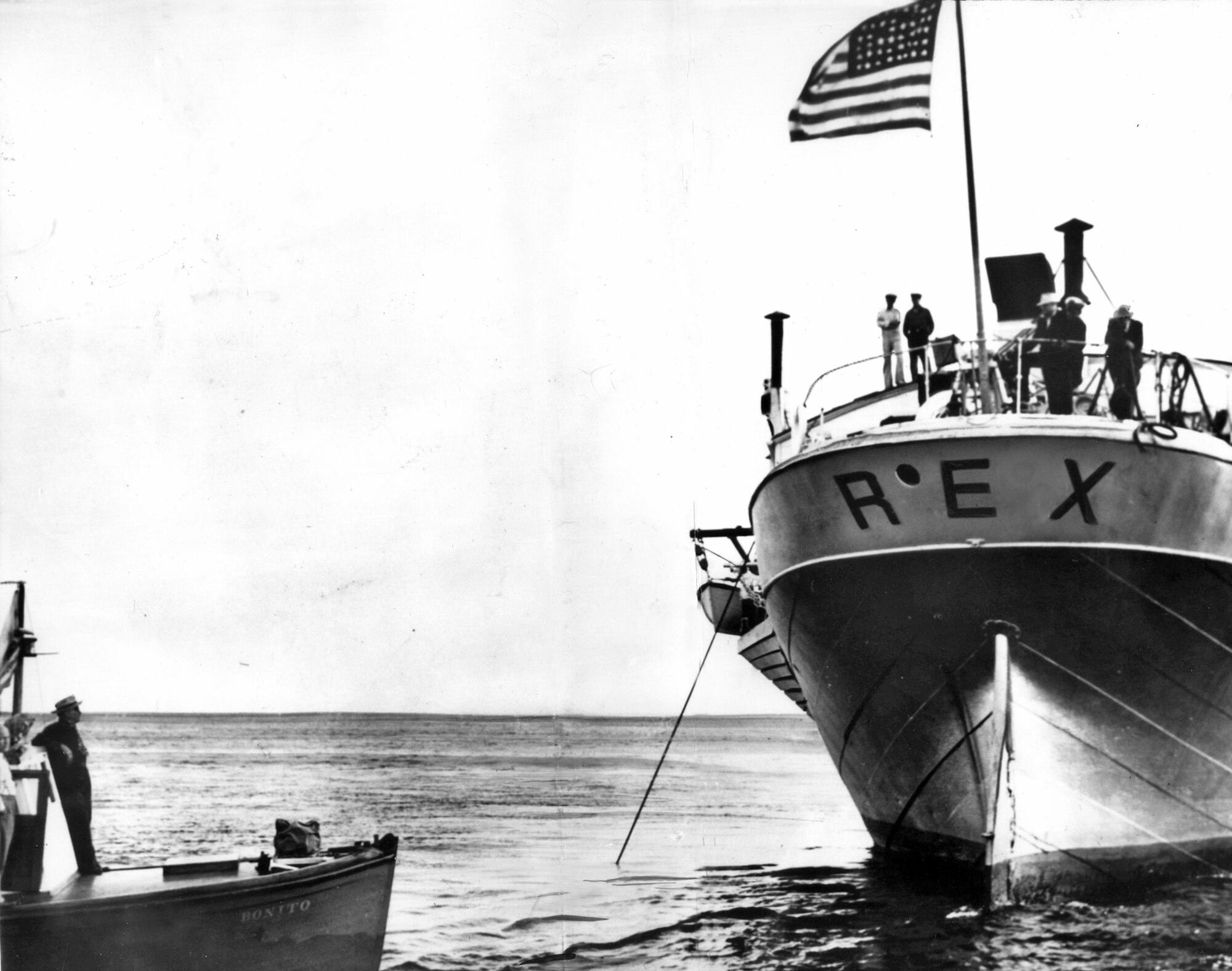 A law enforcement agent aboard a government boat, left, keeps an eye on the Rex on Aug. 4, 1939.