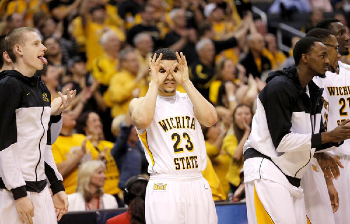 Wichita State guard Fred Van Vleet (23) gives the three-point sign after a teammate's long-range basket against La Salle in the second half of a West Regional semifinal game Thursday night at Staples Center.