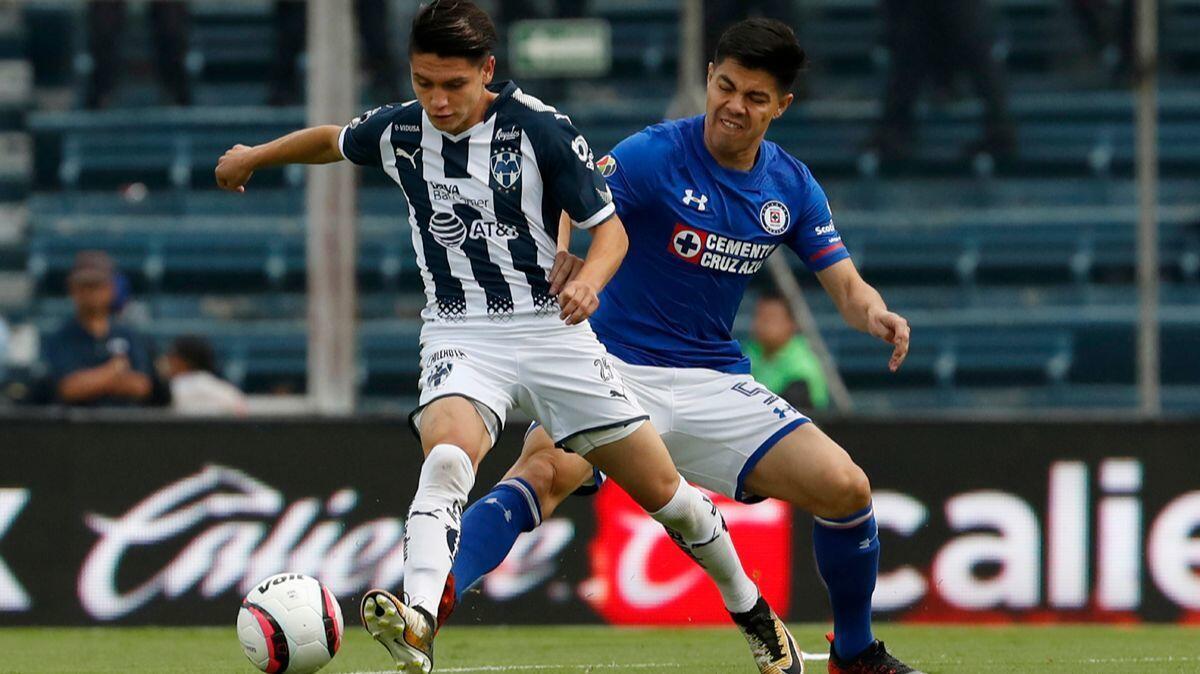 Monterrey's Jonathan Gonzalez, left, fights for the ball with Cruz Azul's Francisco Silva during a Mexico soccer league match in Mexico City on Aug. 26, 2017. Gonzalez is leaving the U.S. national team to play for Mexico.
