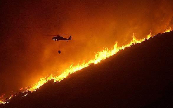 The 2003 Cedar fire in San Diego County was the state's worst in 75 years. Here, a water-dropping helicopter attacks flames in the town of Descanso, east of San Diego.
