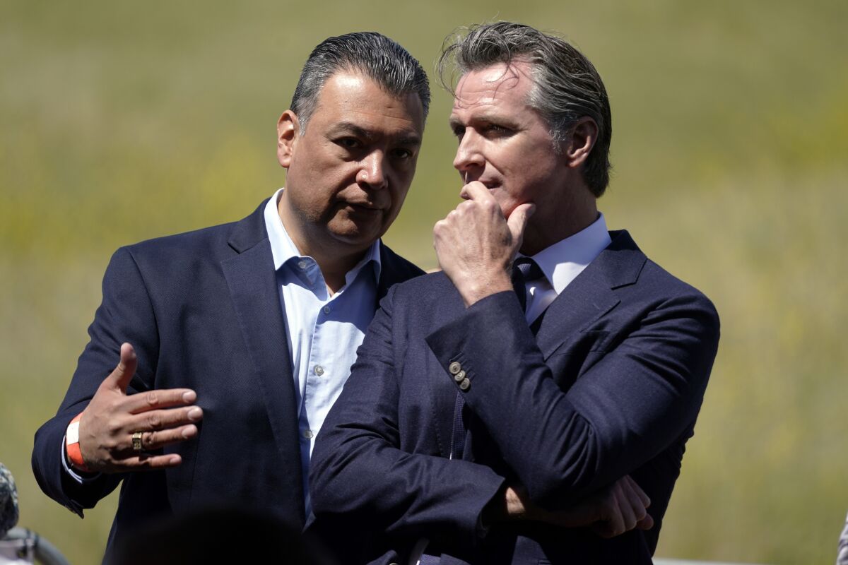 FILE - California Gov. Gavin Newsom, right, talks to Sen. Alex Padilla, D-Calif., during a groundbreaking ceremony for the Wallis Annenberg Wildlife Crossing, Friday, April 22, 2022, in Agoura Hills, Calif. Newsom and Padilla coasted to November runoffs in which they are heavily favored, but preliminary results suggested a slight dip in enthusiasm for two of the state's leading politicians. (AP Photo/Marcio Jose Sanchez, File)