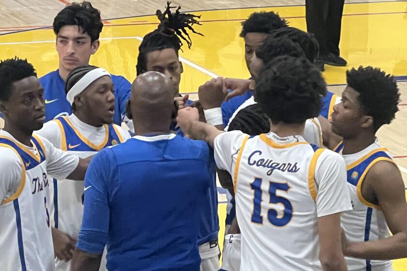 Crenshaw coach Ed Waters gathers his team during a timeout.