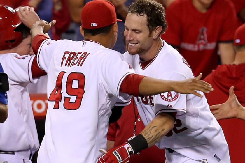 Angels right fielder Josh Hamilton is congratulated by closer Ernesto Frieri after his walk-off home run against the Boston Red Sox on Saturday night in Anaheim.