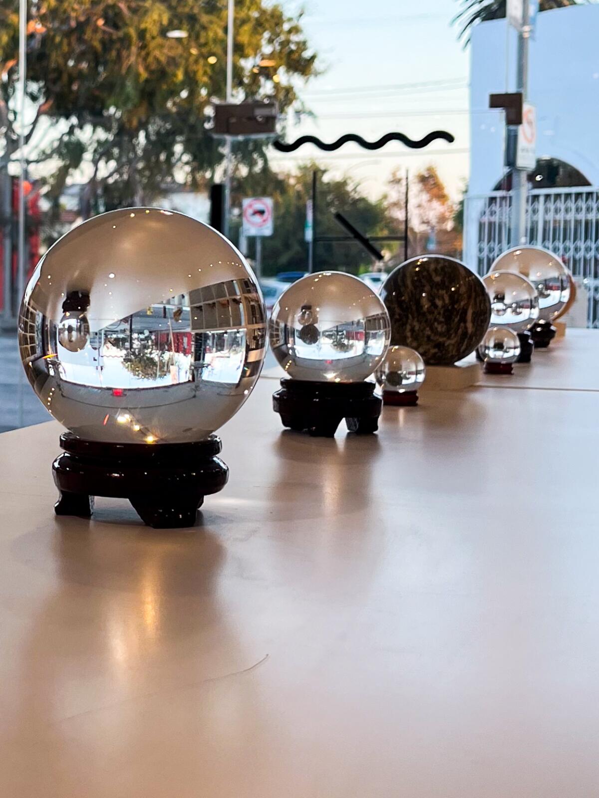 A line of crystal balls adorns a shelf at the House of Intuition.