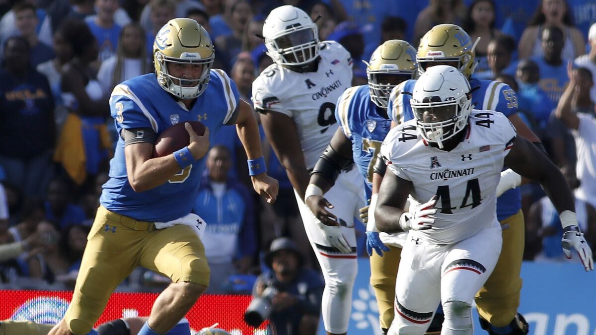 UCLA quarterback Wilton Speight breaks free for a long gain against Cincinnati.